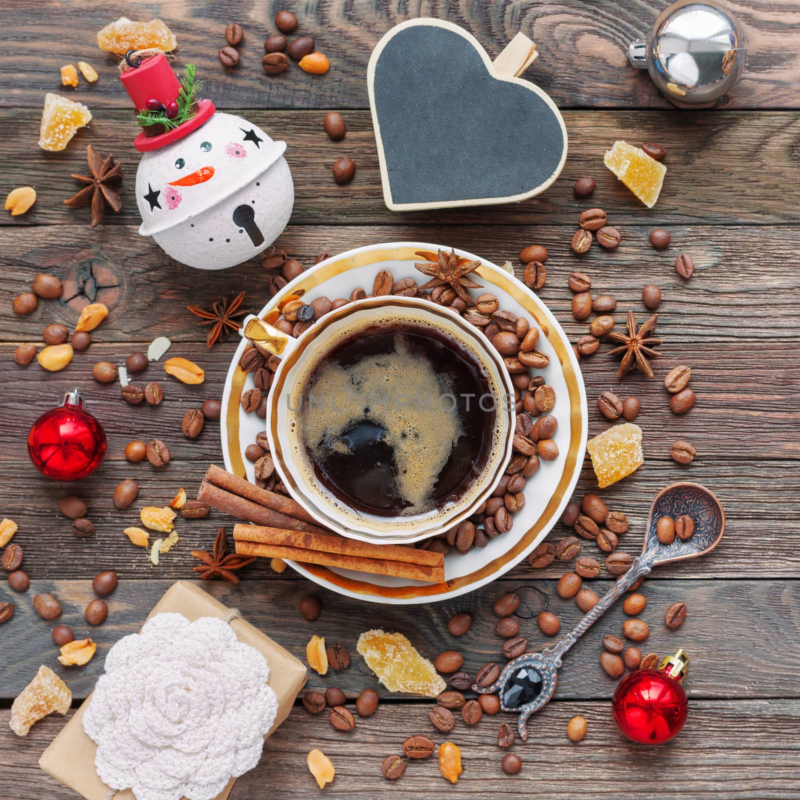 Rustic wooden background with cup of coffee and New Year decorat by aksenovko
