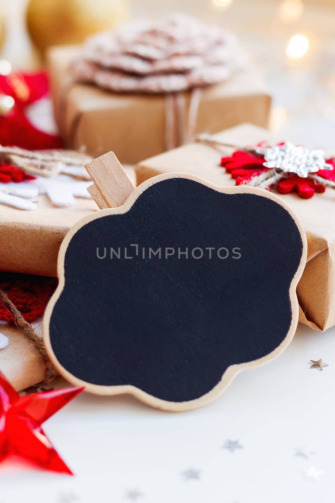 Christmas and New Year background with cloud chalkboard, presents and decorations for Christmas tree. Holiday background with stars confetti and light bulbs. Place for text.