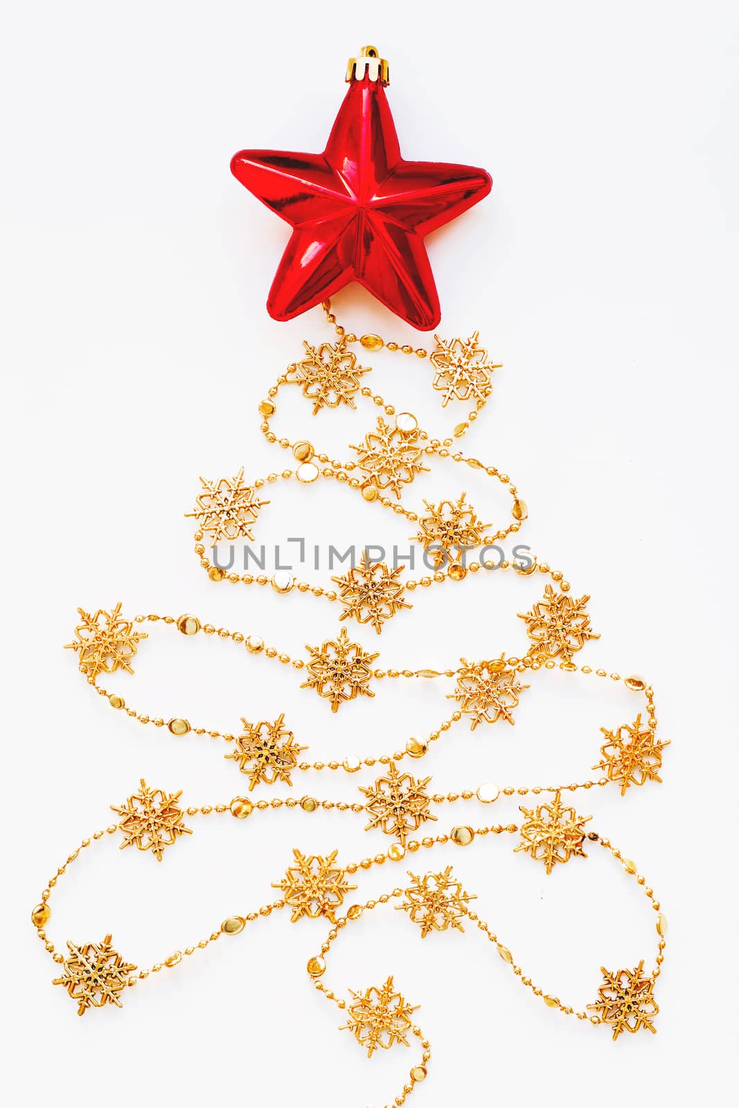 Christmas Tree made of golden snowflake garland with red bright star. New Year symbol. Flat lay, top view.