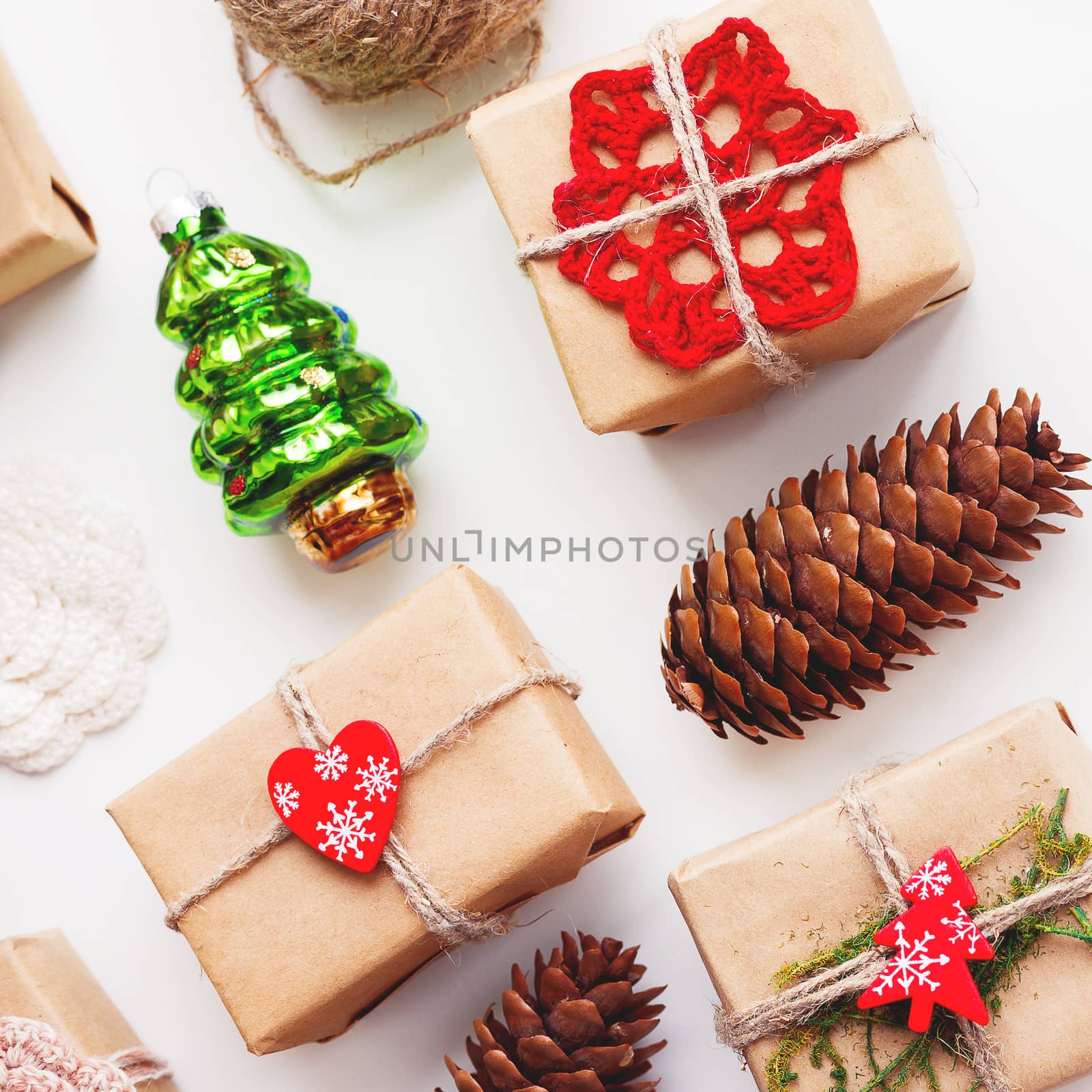 Christmas and New Year background with handmade presents wrapped in craft paper and decorations, holiday symbols.