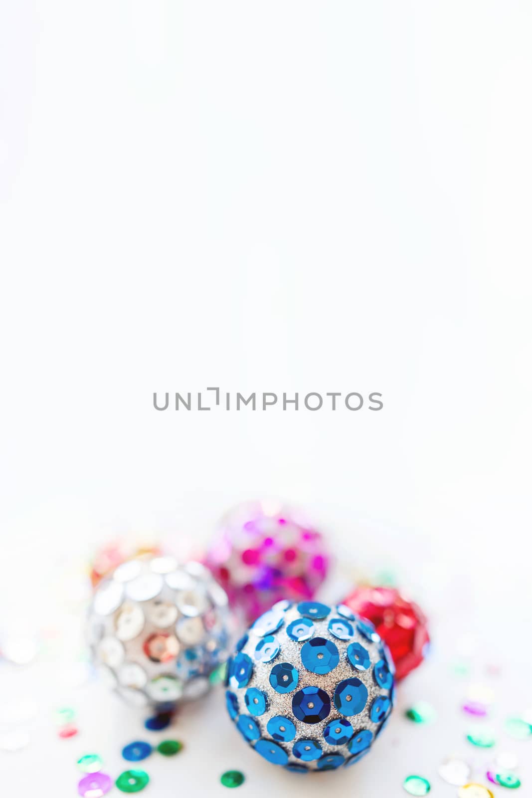 Christmas and New Year background with bright balls. Hand made decorations for Christmas tree with colorful sparkling spangles. Place for text.