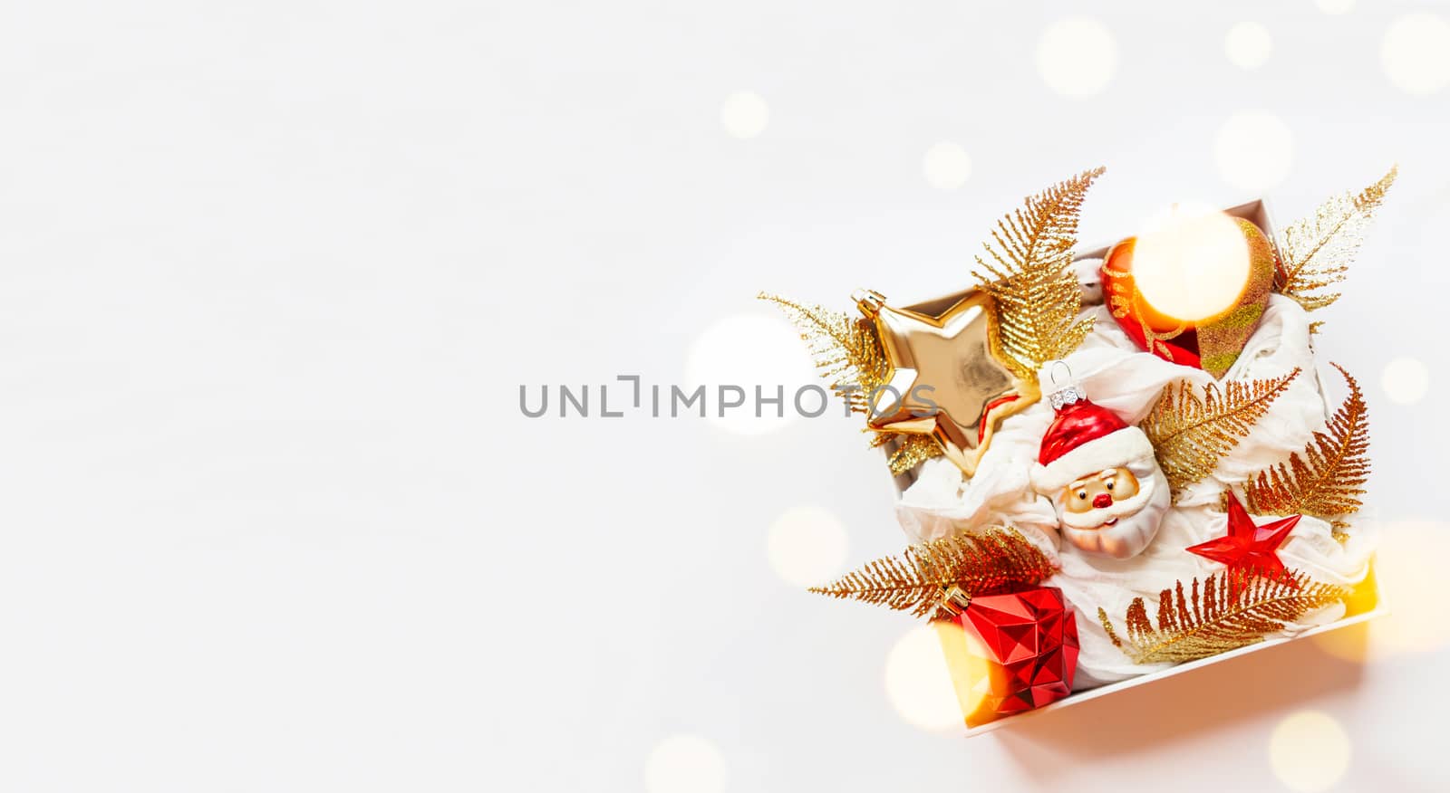 Banner - white box with New Year decorations. Bright red and golden decorative toys for Christmas tree.
