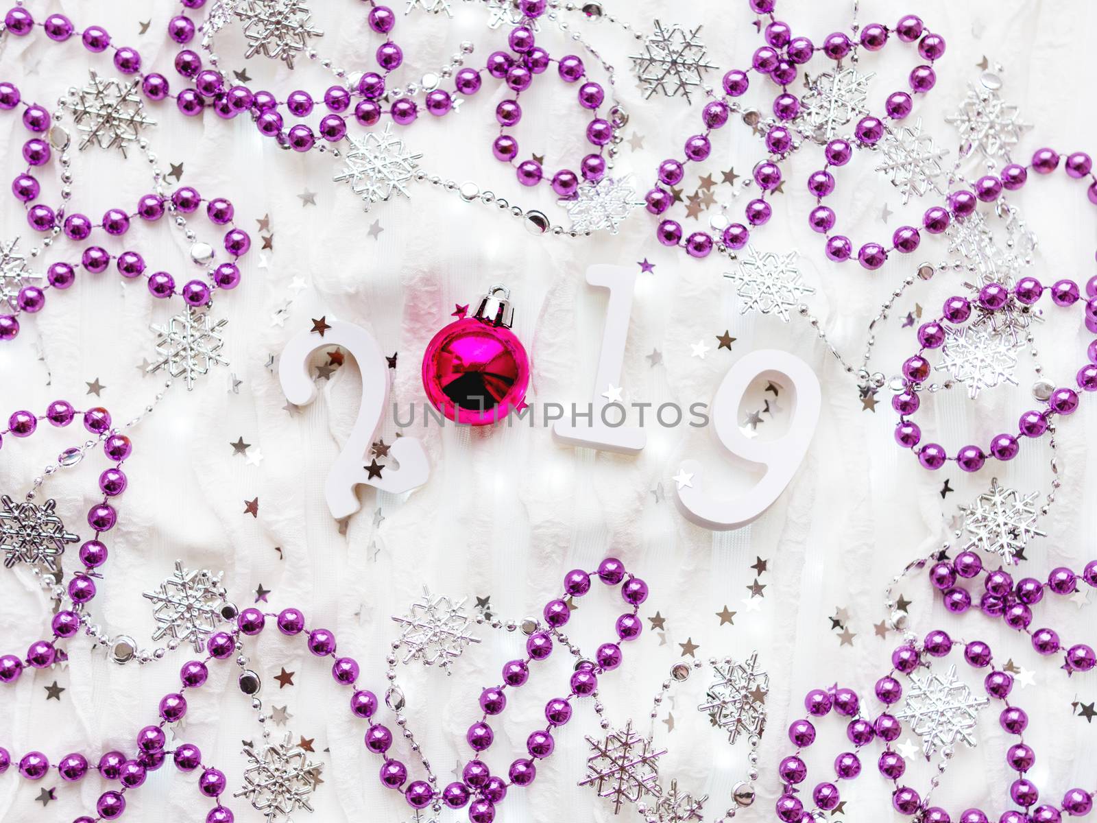 Christmas and New Year background with numbers 2019, silver decorations and light bulbs.
