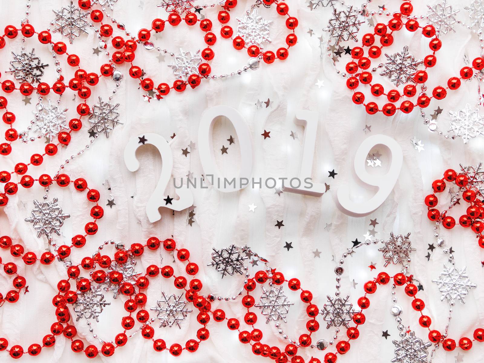 Christmas and New Year background with numbers 2019, silver decorations and light bulbs.