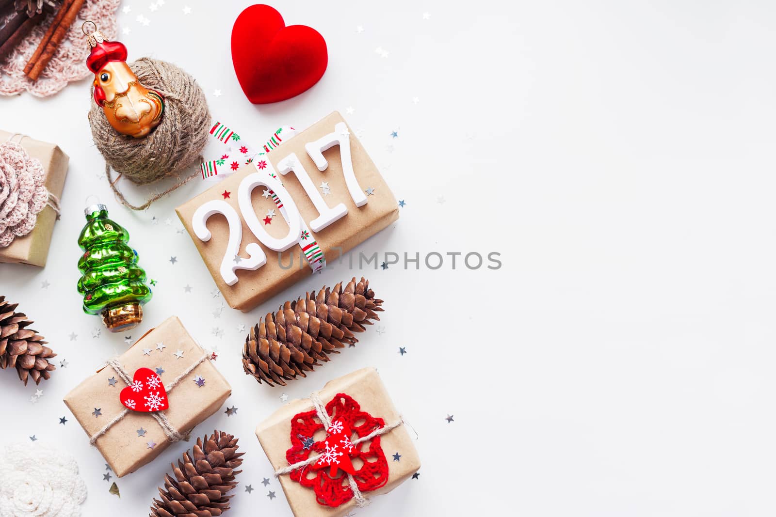 Christmas and New Year background with handmade presents wrapped in craft paper and decorations, holiday symbols. Place for text.