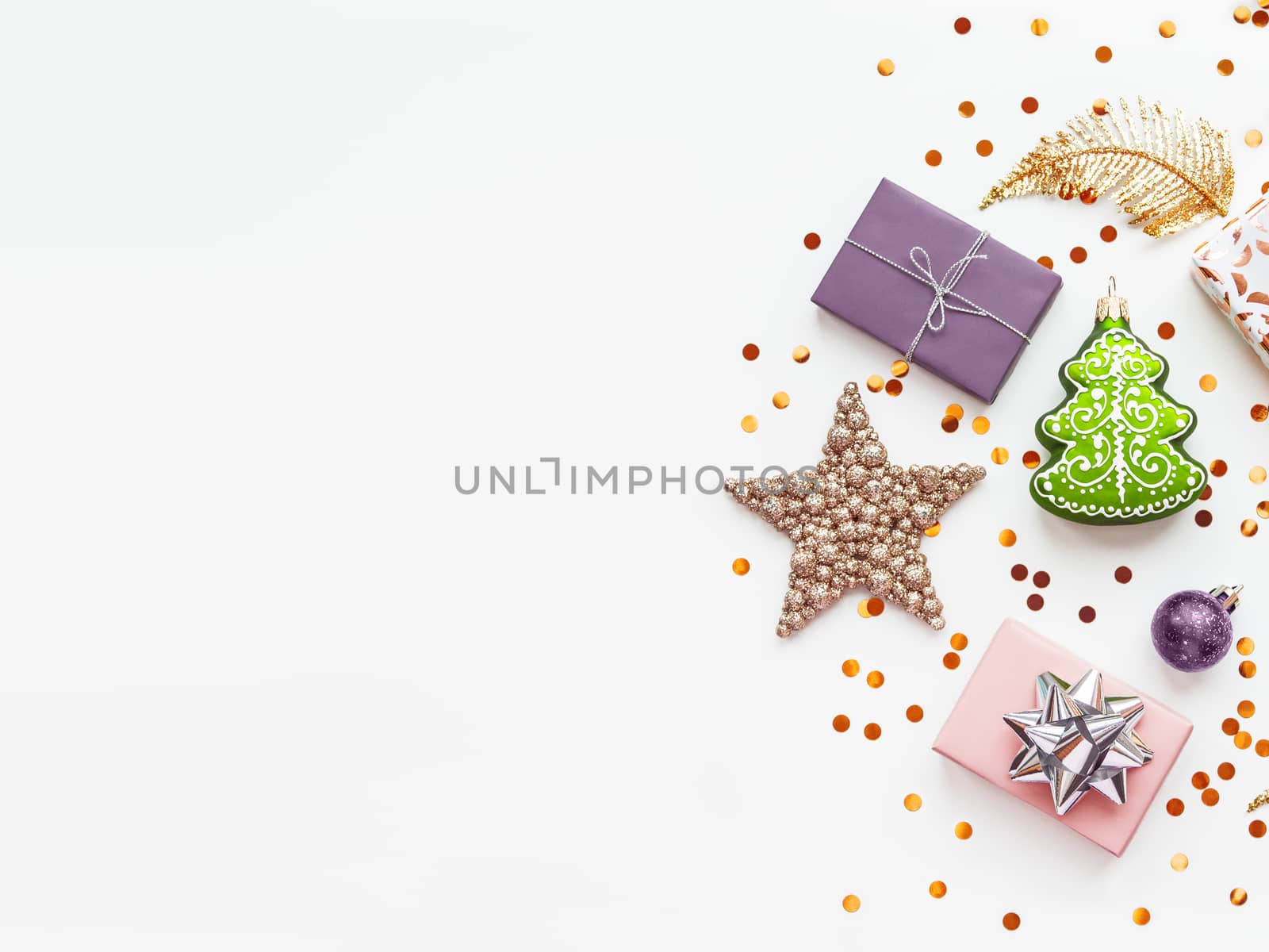 Christmas and New Year 2020 background with decorations. Green fir tree, golden feathers, presents and stars confetti.