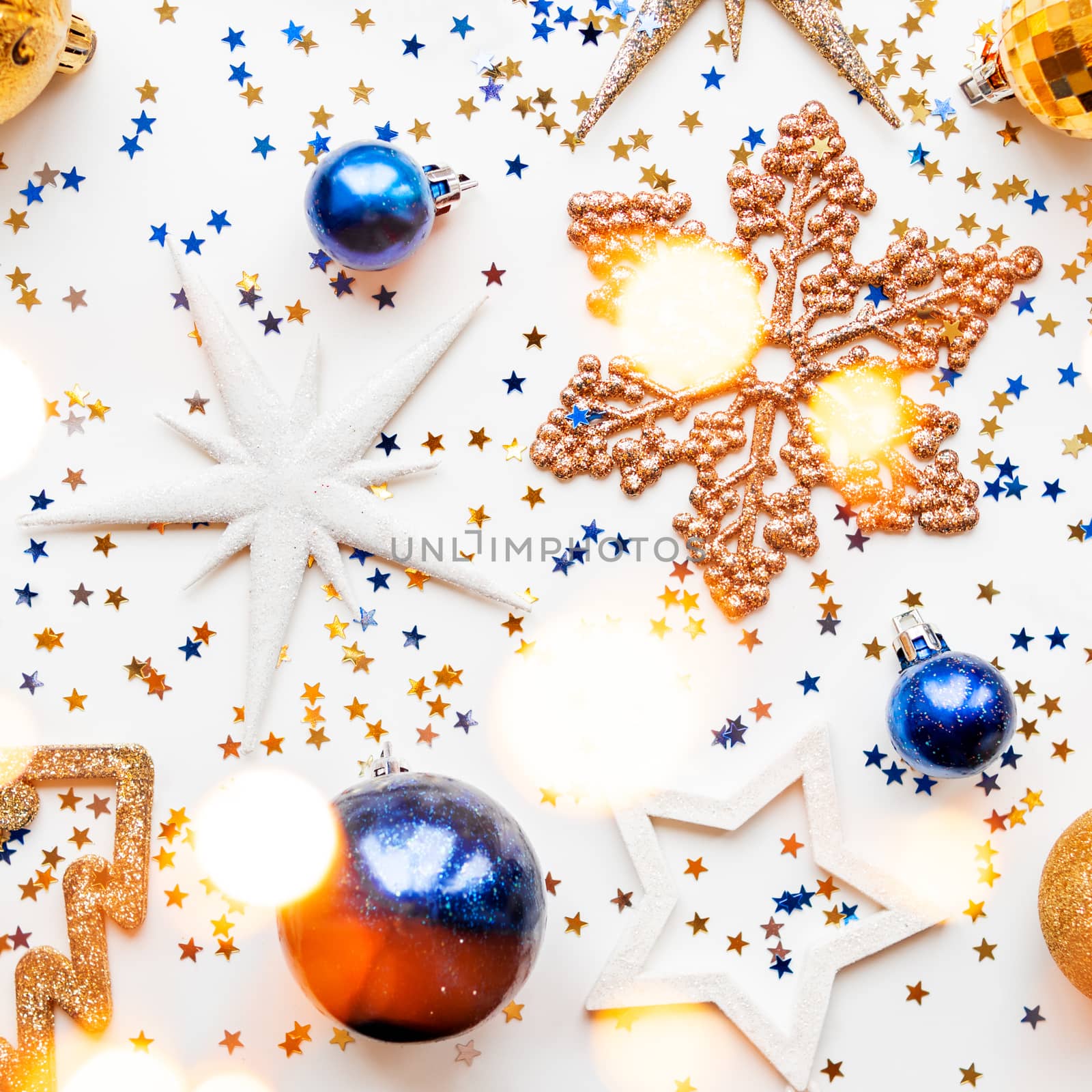 Christmas and New Year background with decorations - shiny stars, balls, snowflakes and confetti.