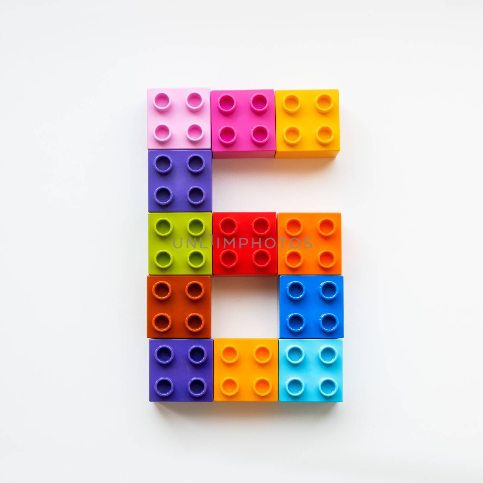 Number Six made of colorful constructor blocks. Toy bricks lying by aksenovko