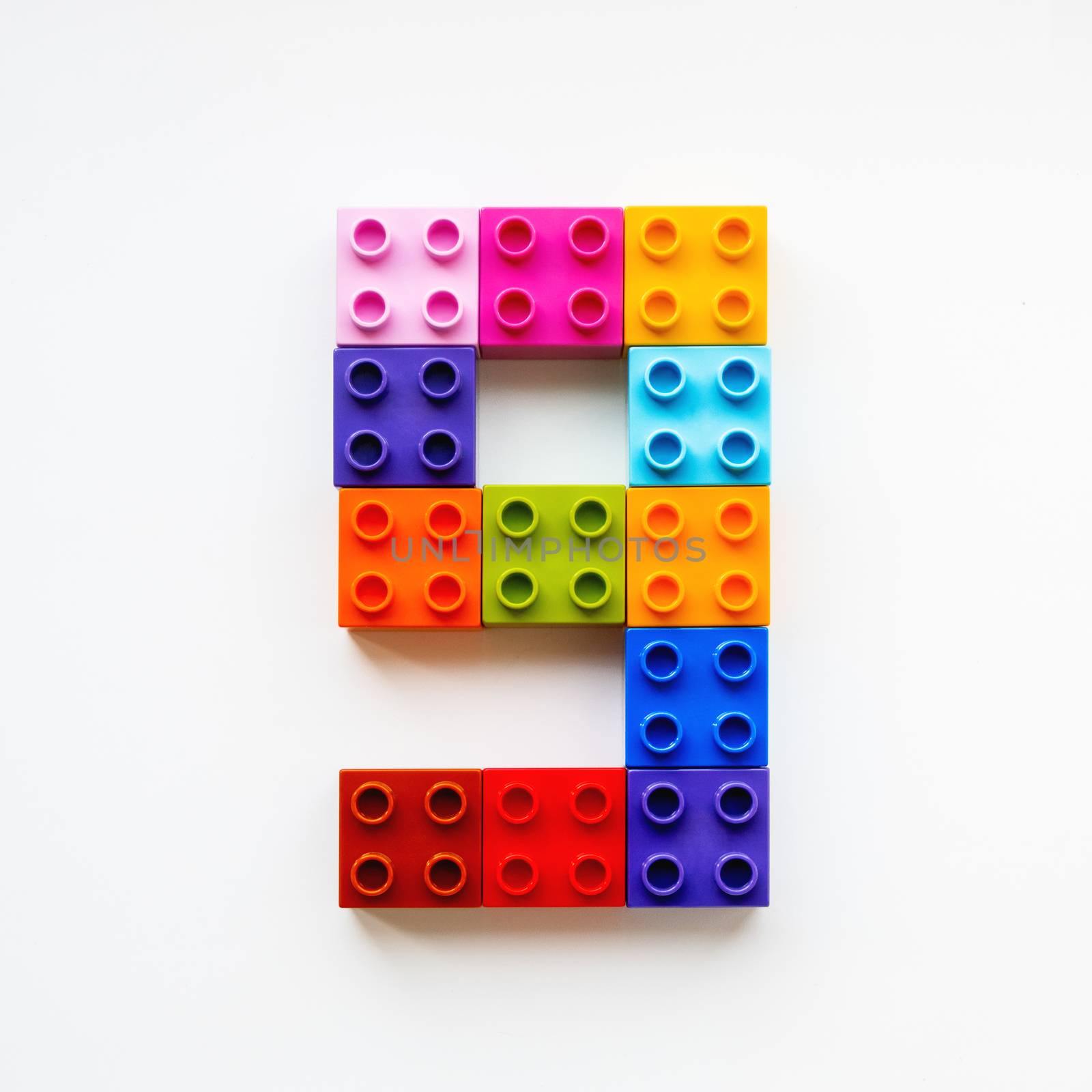 Number Nine made of colorful constructor blocks. Toy bricks lying in order, making number 9. Education process - learning numbers with child using multicolored toy details.
