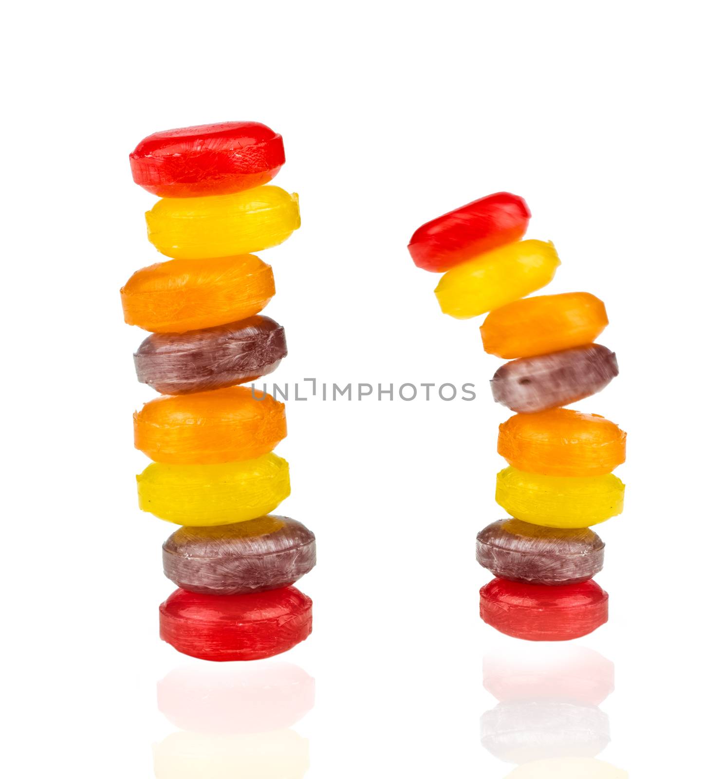 Medical lozenges for relief cough, sore throat and throat irritation isolated on white background. Cough and colds drop. Colorful cough pastille. Red, orange, yellow, and purple round candy or sweets.