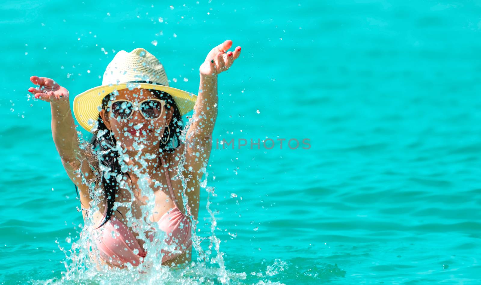 Happy young Asian woman in pink swimsuit relax and enjoy holiday by Fahroni