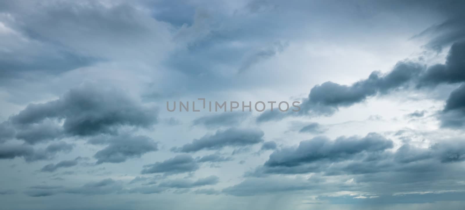 Dark dramatic sky and clouds. Background for death and sad concept. Gray sky and fluffy white clouds. Thunder and storm sky. Sad and moody sky. Nature background. Dead abstract background. Cloudscape.