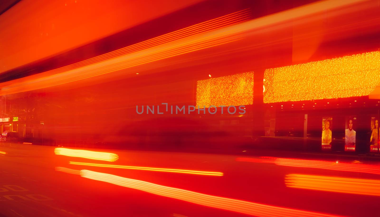 City street in the night with blurred fast speed car light. Red and yellow light at the rod beside the building. Night light abstract background. Blurred motion of light on the road.