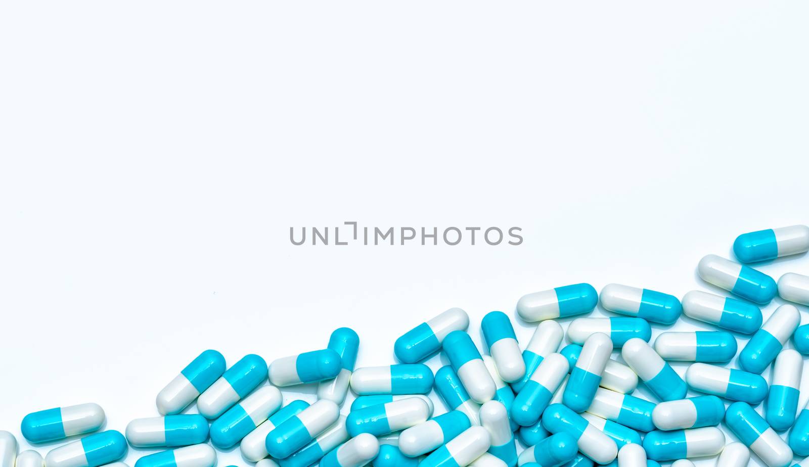 Pile of antibiotic capsule pills isolated on white background. Global market trends of antimicrobial drugs concept. Antibiotic drug resistance. Pharmaceutical industry. Pharmacy drugstore products.