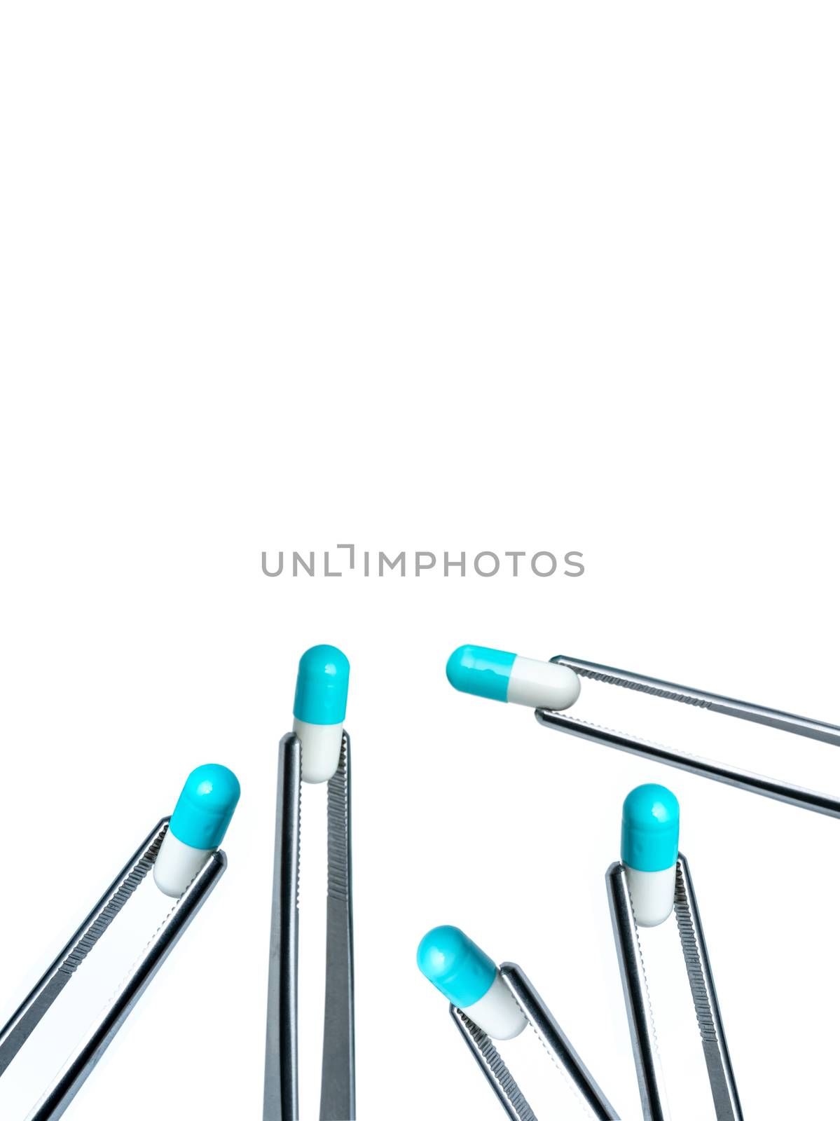 5 forceps pick white-blue capsule isolated on white background. Drugs choose. Drug selection in laboratory for test. Antibiotic drug resistance concept. QA and QC in pharmaceutical factory concept. 