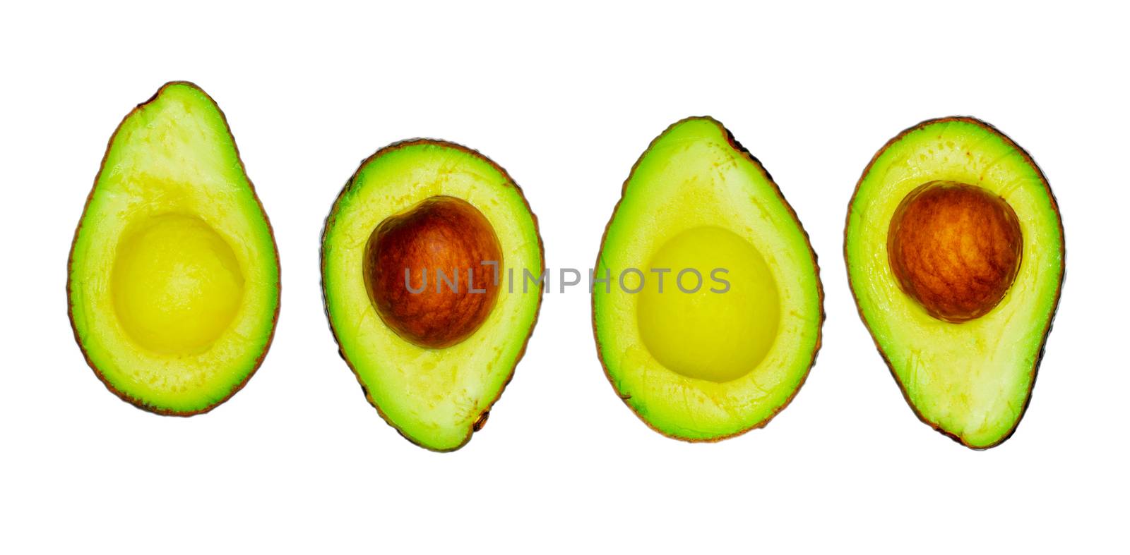 Avocado with seed isolated on white background. Source of omega 3 from natural food. Healthy food for baby. Half pieces of avocados arranged with beautiful pattern. Organic food for vegetarian.