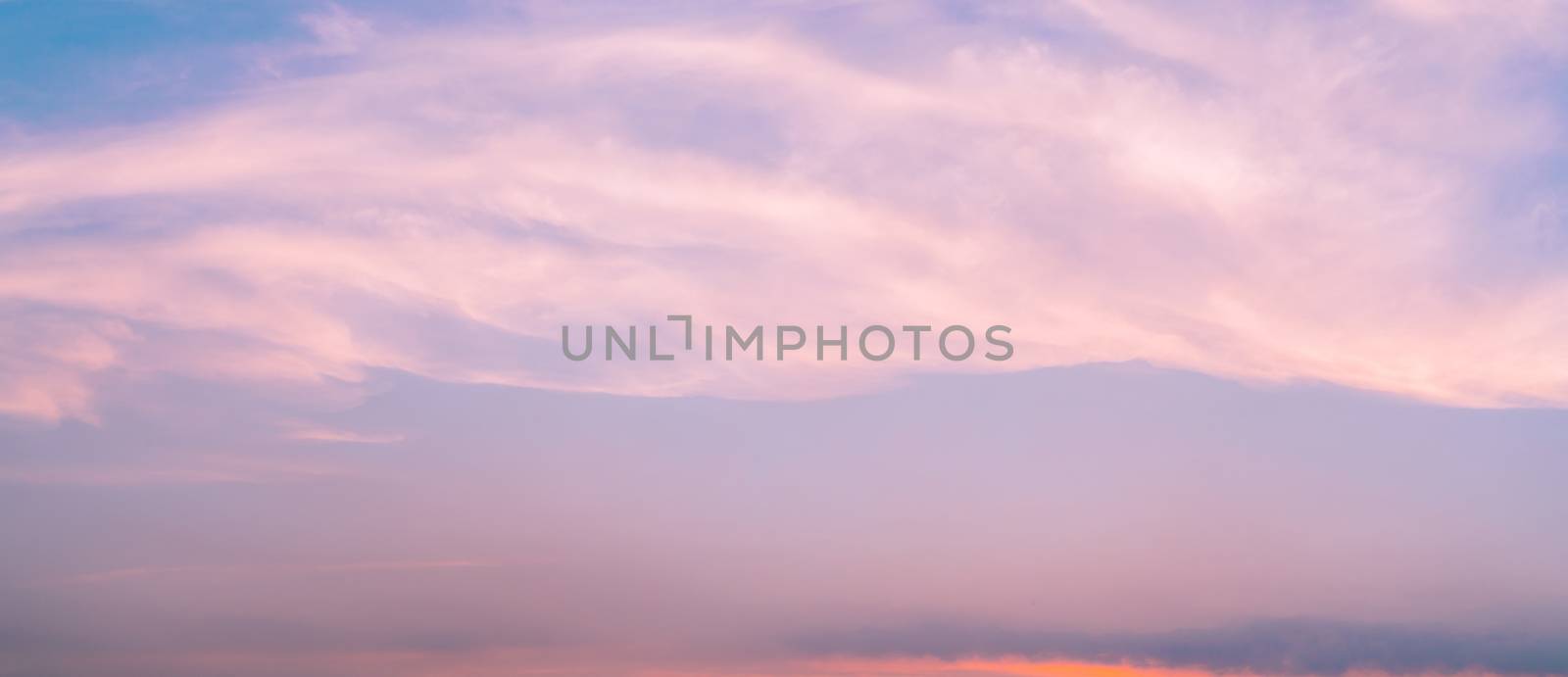 Dramatic pink sky and clouds abstract background. Art picture of pink clouds texture. Beautiful sunset sky. Sunset abstract background. Pastel color sky in the evening. Calm and relax life. Happy love