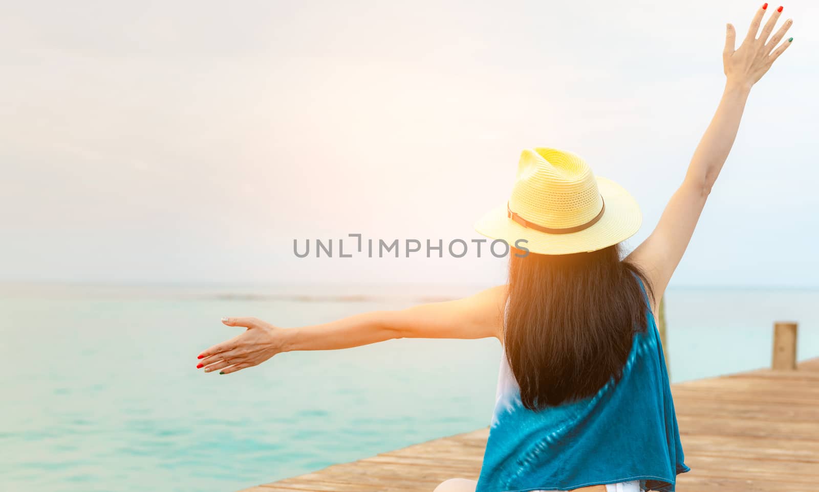 Back view of happy young Asian woman in casual style fashion and by Fahroni