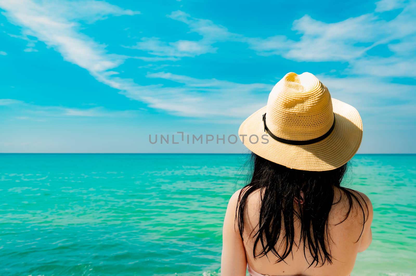 Back view of sexy and happy young Asian woman wear straw hat rel by Fahroni