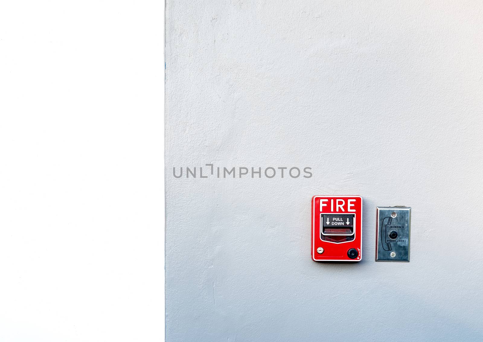 Fire alarm on white concrete wall. Warning and security system.  by Fahroni