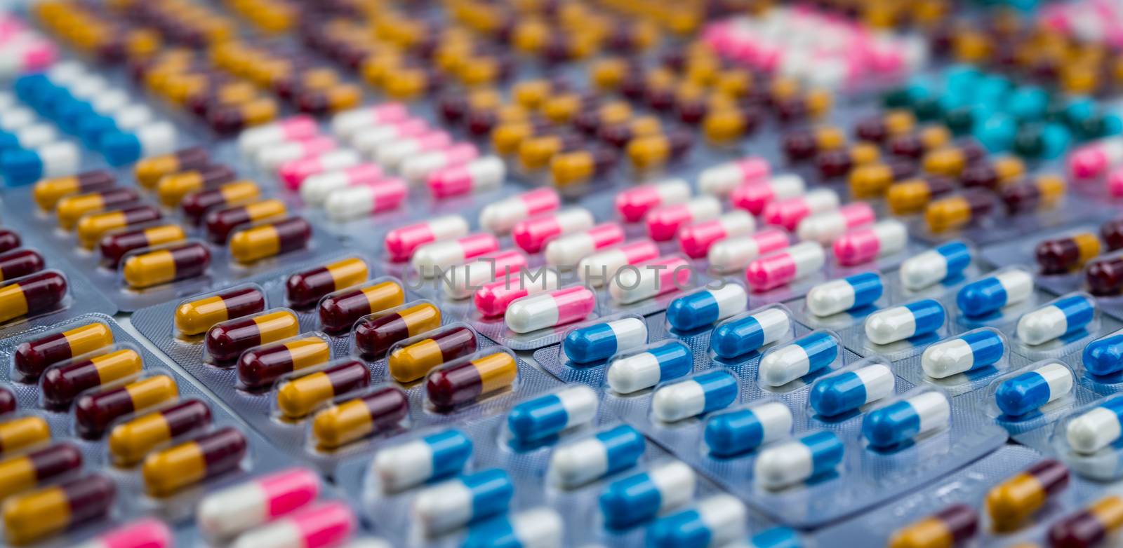 Selective focus on colorful antibiotic capsule pills in blister  by Fahroni