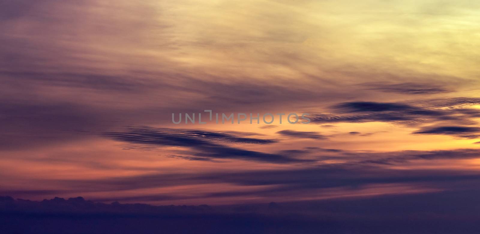 Dramatic orange sunset sky. Romantic sky. Colorful sunset. Art picture of sky at sunset. Sunset sky and clouds for inspiration background. Nature background. Peaceful and tranquil concept.