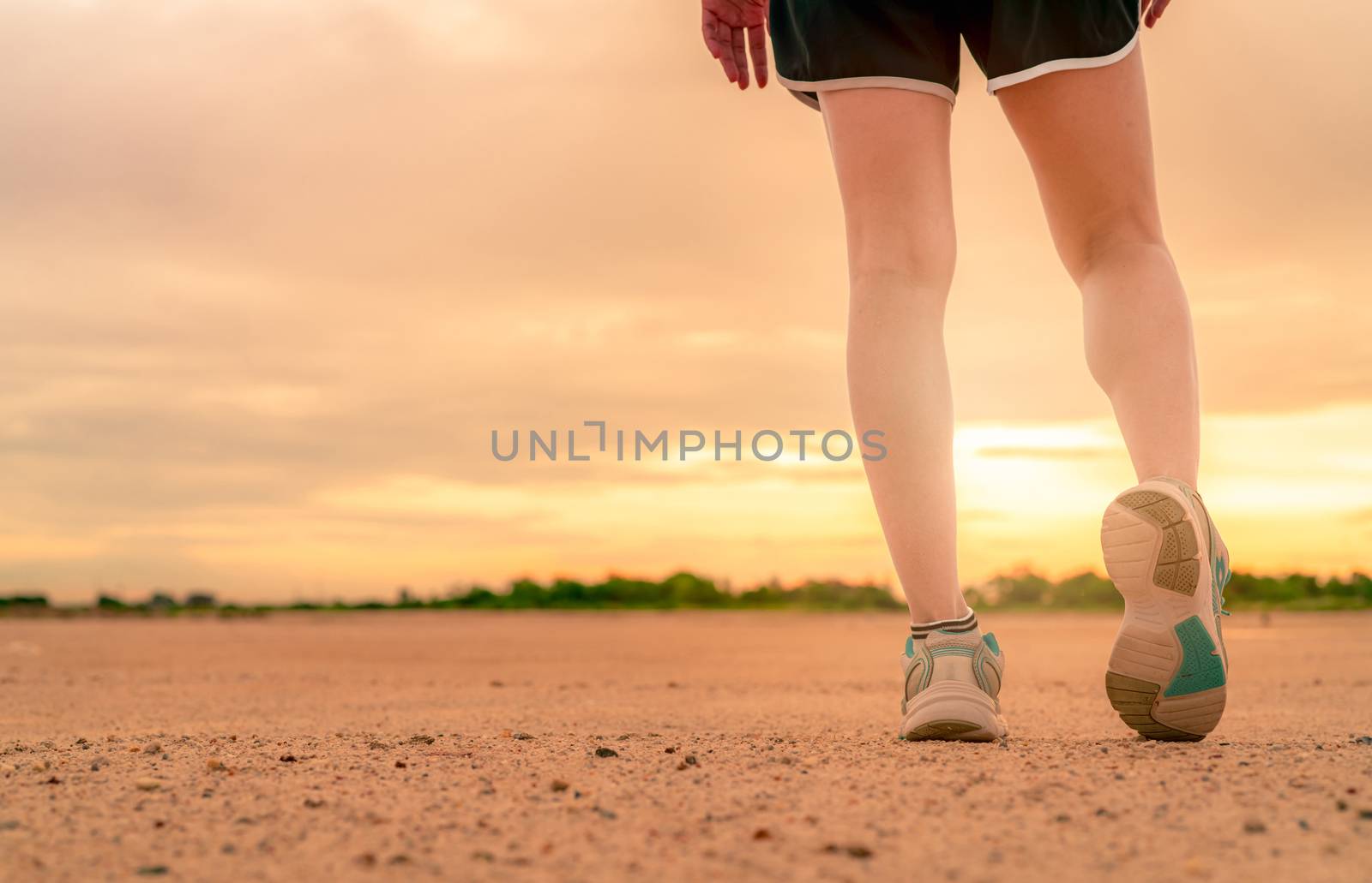 Woman runner wear sport shoes and warming up before run at the park in the morning. Asian female cardio exercise for healthy life. Jogging outdoor. Fit girl training for marathon. Summer lifestyle.