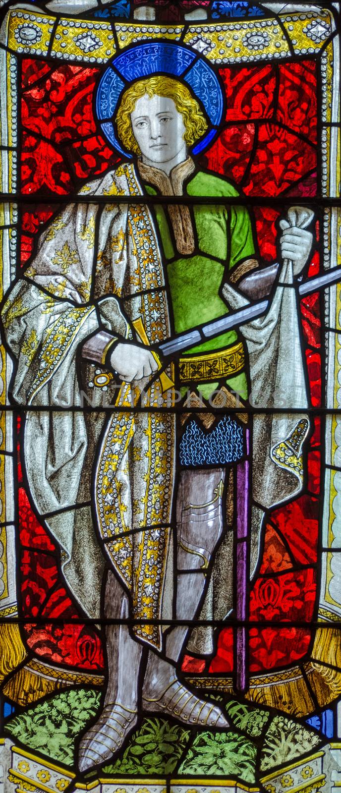 Victorian stained glass window showing Saint Martin, the Roman Soldier who cut up his cloak to give to a needy person.  Historic church window on public display for 120 years.