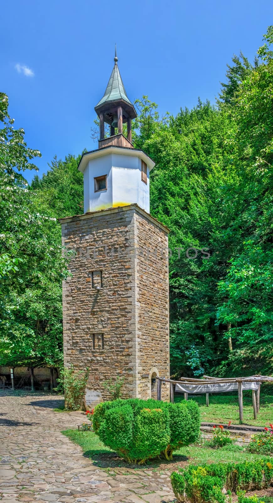 Gabrovo, Etar, Bulgaria - 07.27.2019. Clock tower in the Etar Architectural Ethnographic Complex in Bulgaria on a sunny summer day. Big size panoramic photo.