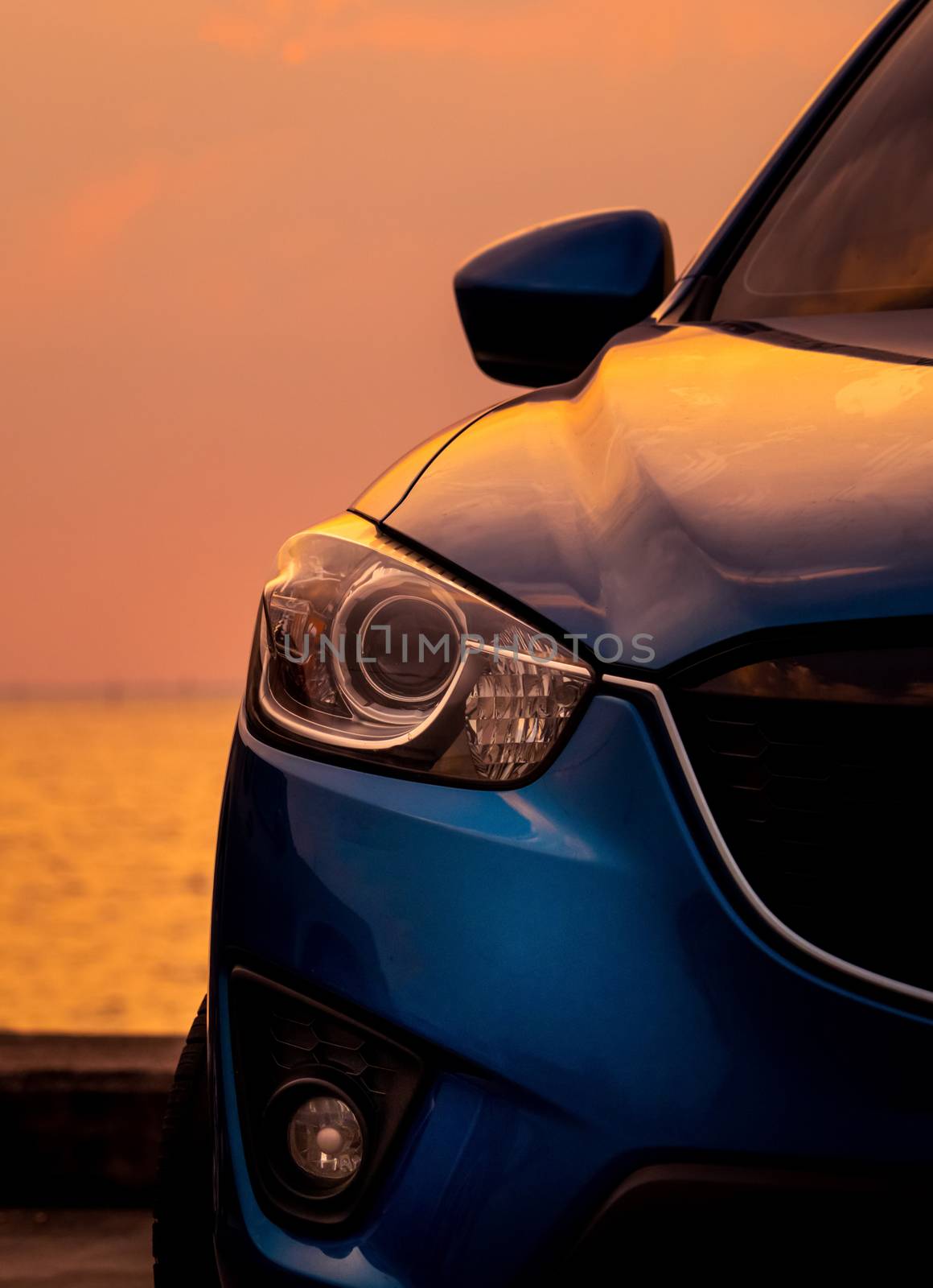 Front view of blue SUV car with sport and modern design parked o by Fahroni