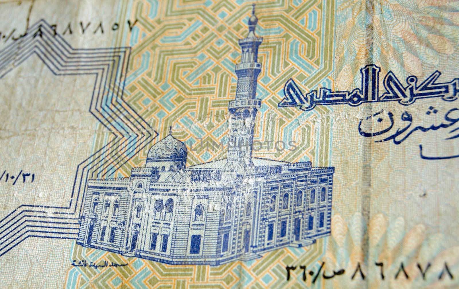 Reverse of the 25 piastres banknote from Egypt showing the historic Al-Sayida Aisha Mosque in Cairo.  Used and slightly battered banknote, photographed at an angle.