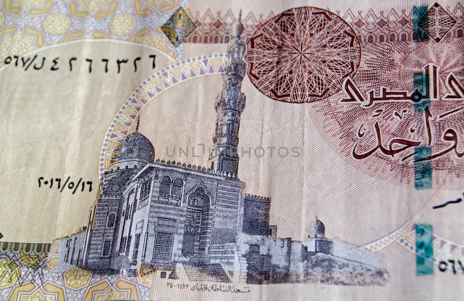 The mosque of Sultan Qait Bay in Cairo as depicted on the reverse of a one Egyptian pound banknote.  Used banknote, photographed at an angle.