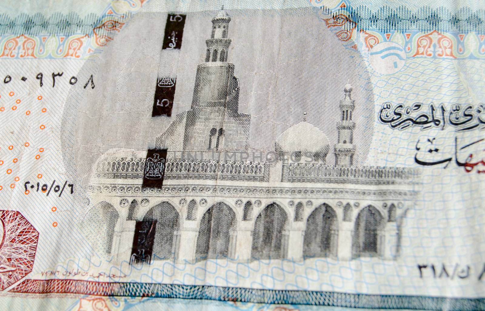 The mosque of Ibn Tulun in Cairo depicted on the reverse of a five pound banknote from Egypt.  Used banknote, photographed at an angle.