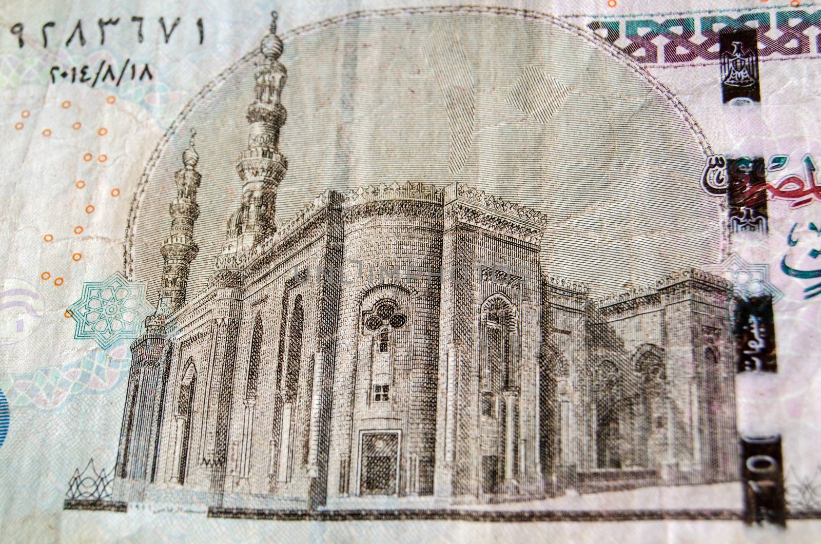 Detail of the Al-Rifai Mosque in Cairo on the back of an Egyptian ten pound note.  Used banknote, photographed at an angle.