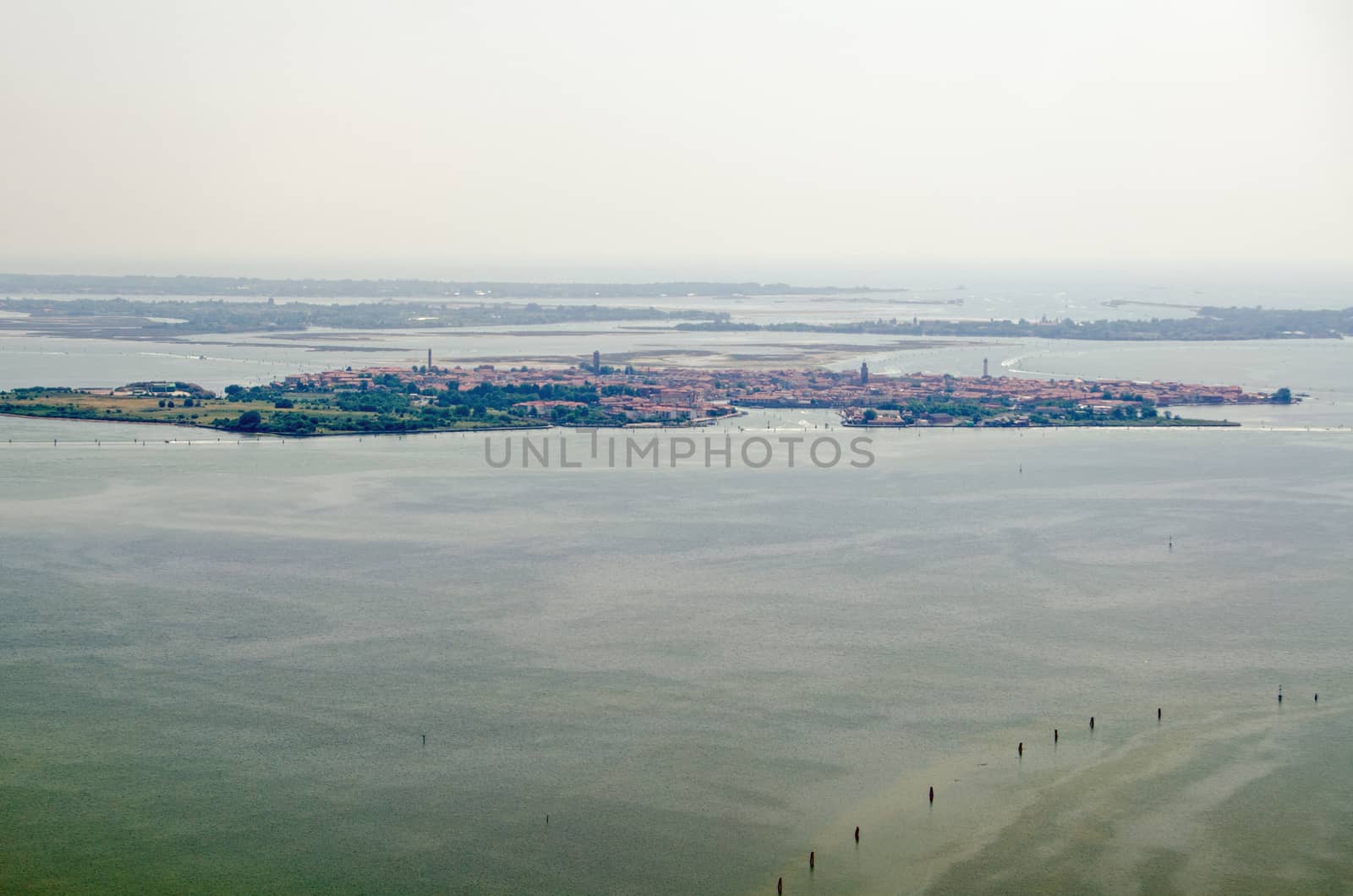 Aerial view of the Venetian Lagoon with the island of Murano to the fore and behind it the less populated Le Vignole and Saint'Erasmo with the Adriatic Sea beyond.