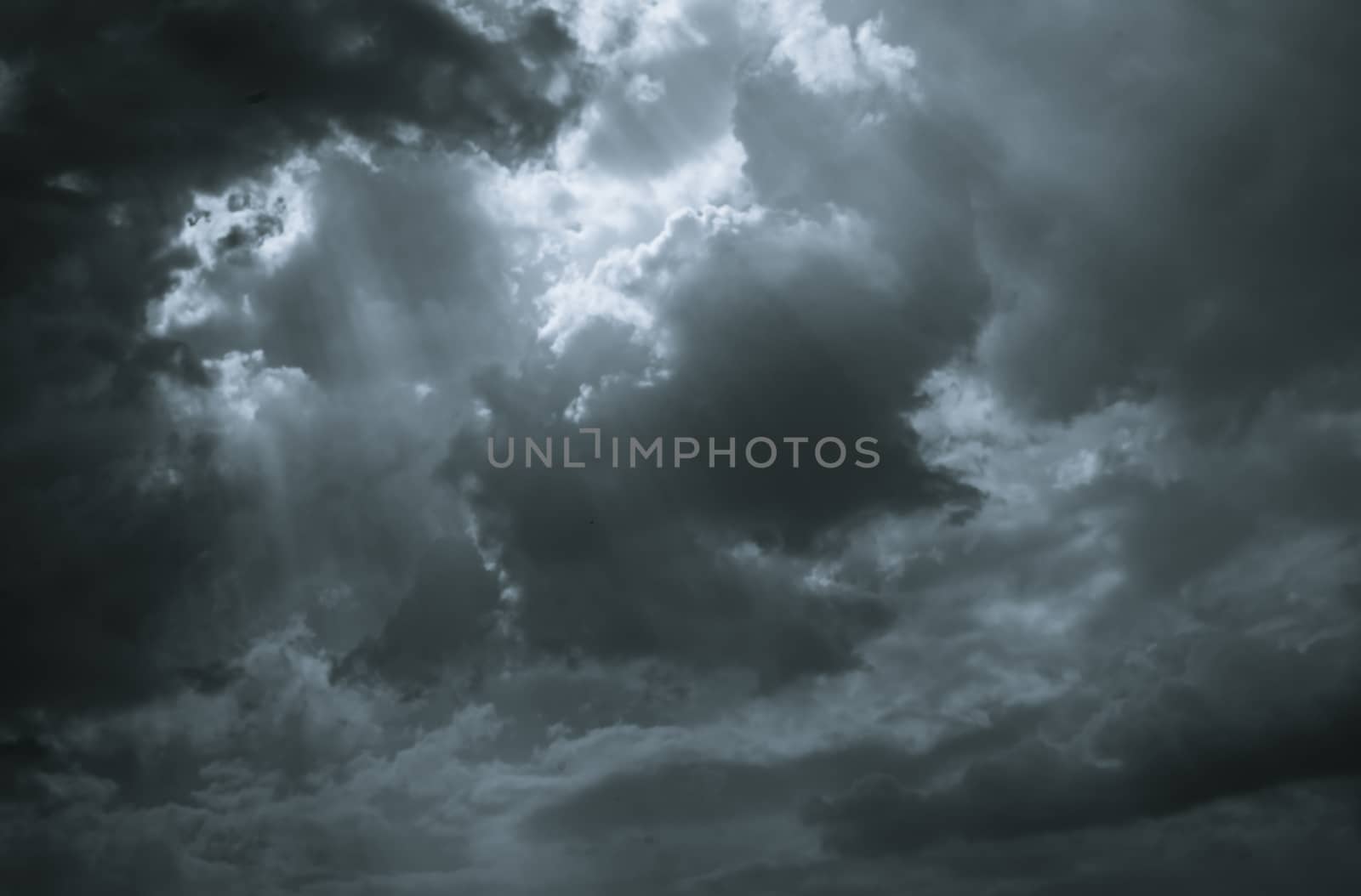 Dark dramatic sky and clouds. Background for death and sad concept. Gray sky and fluffy white clouds. Sad and moody sky. Nature background. Dead abstract background. Cloudscape. Hope in darkness day