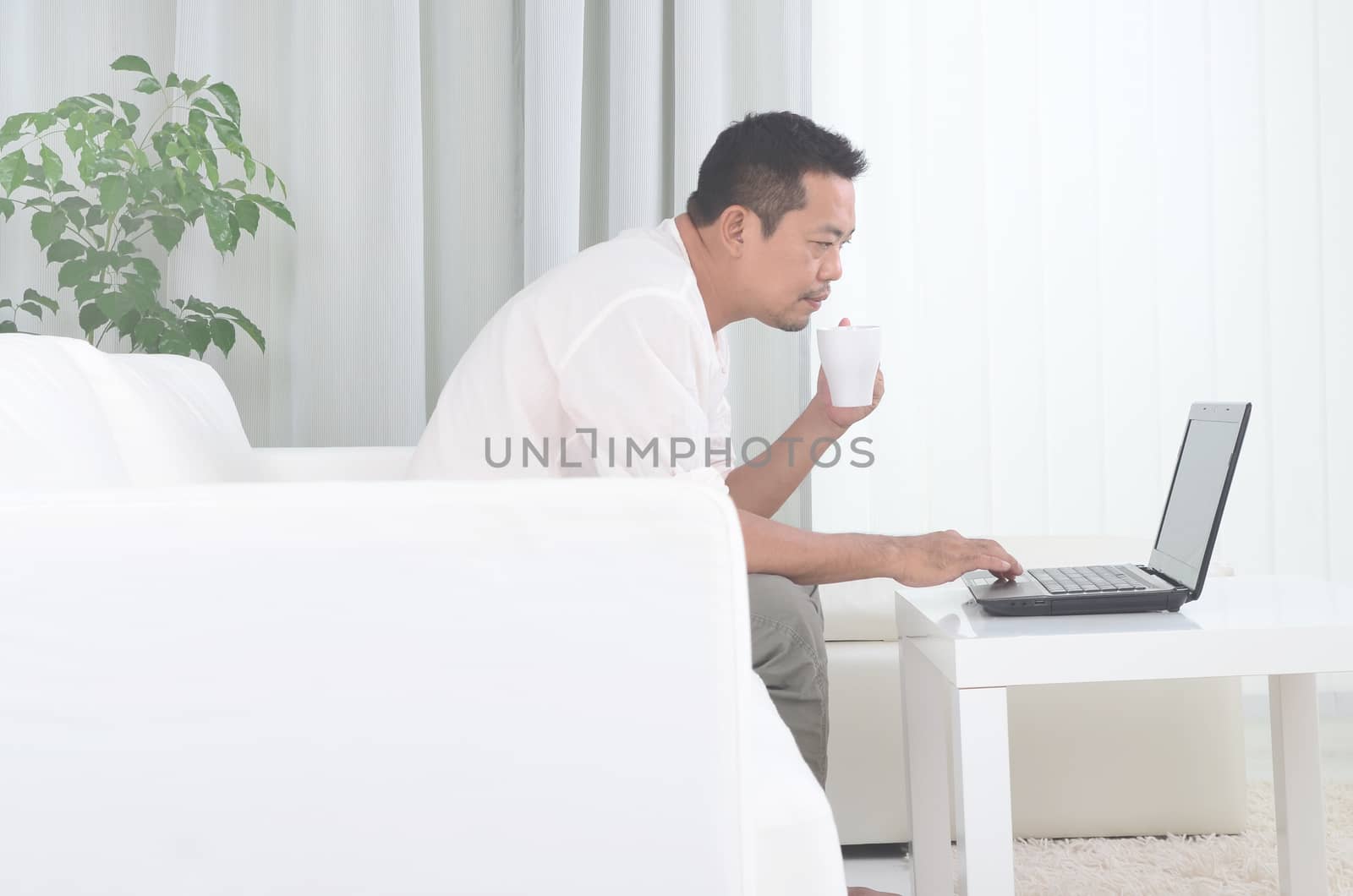 asian man working at home by yongtick