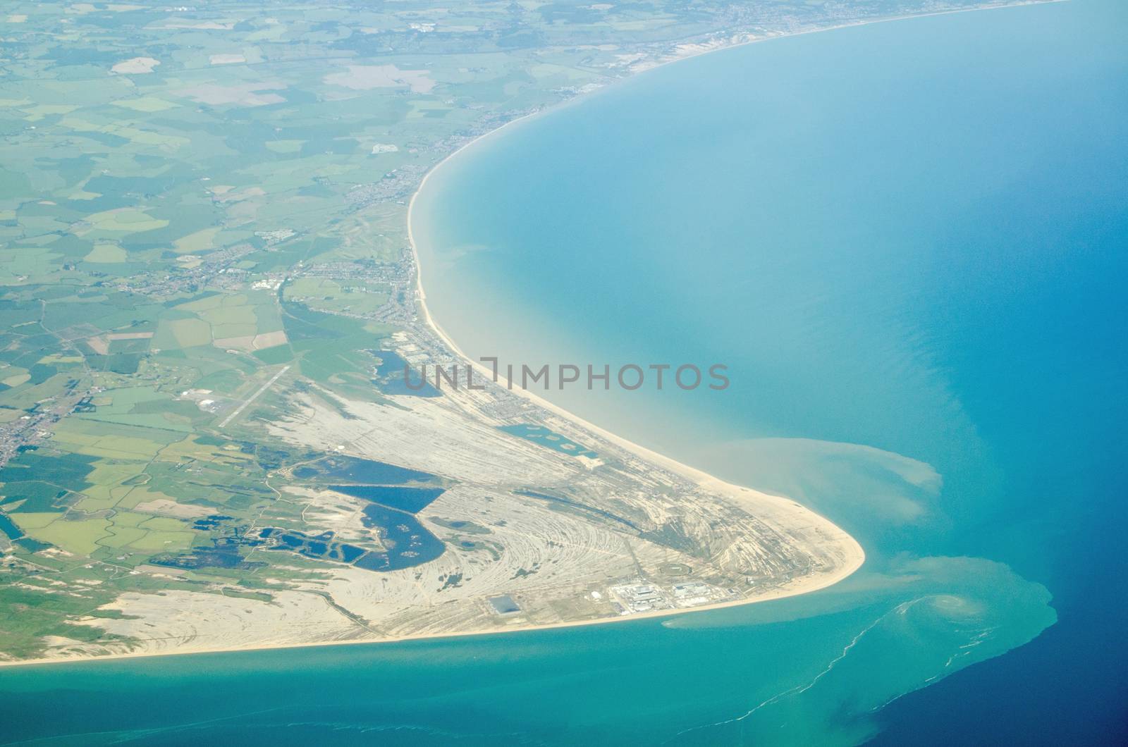 Aerial view of Dungeness headland jutting into the English Channel at Kent, England.  Towards the bottom is the Dungeness nuclear power station and to the left is London Ashford Airport.
