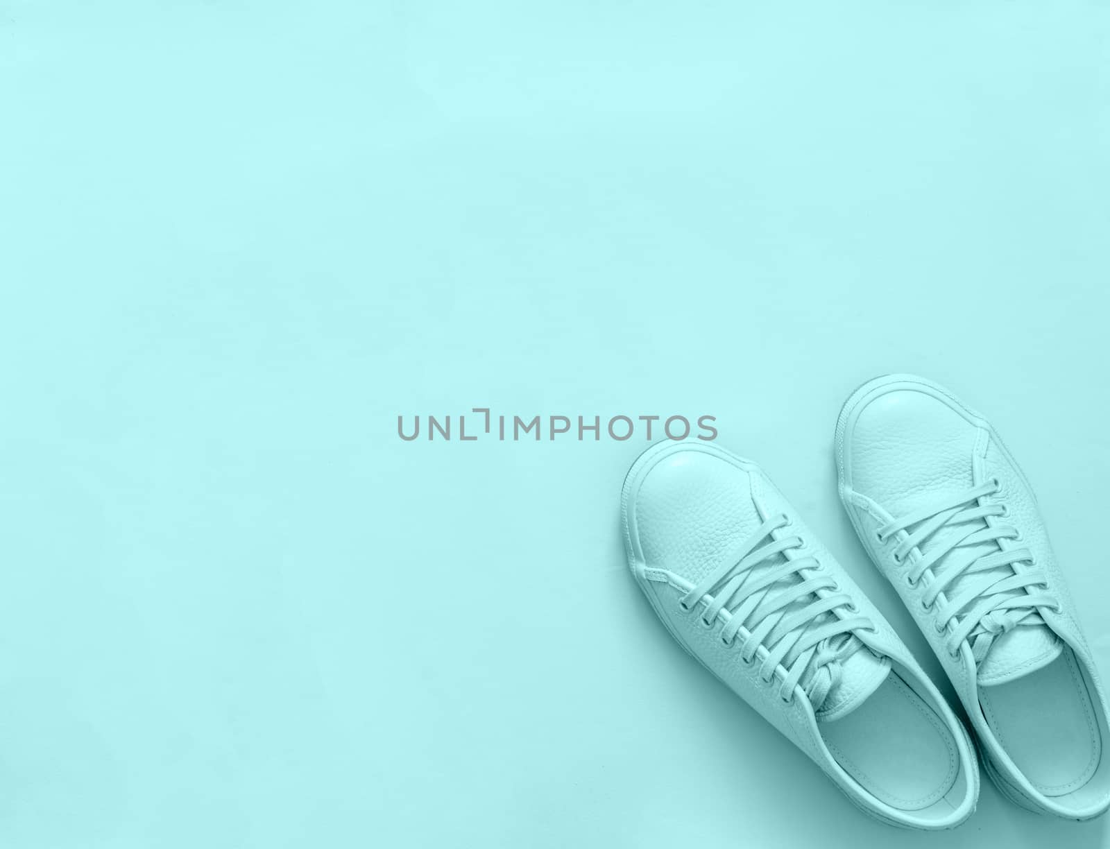 Blue sneakers on blue background, copy space by fascinadora