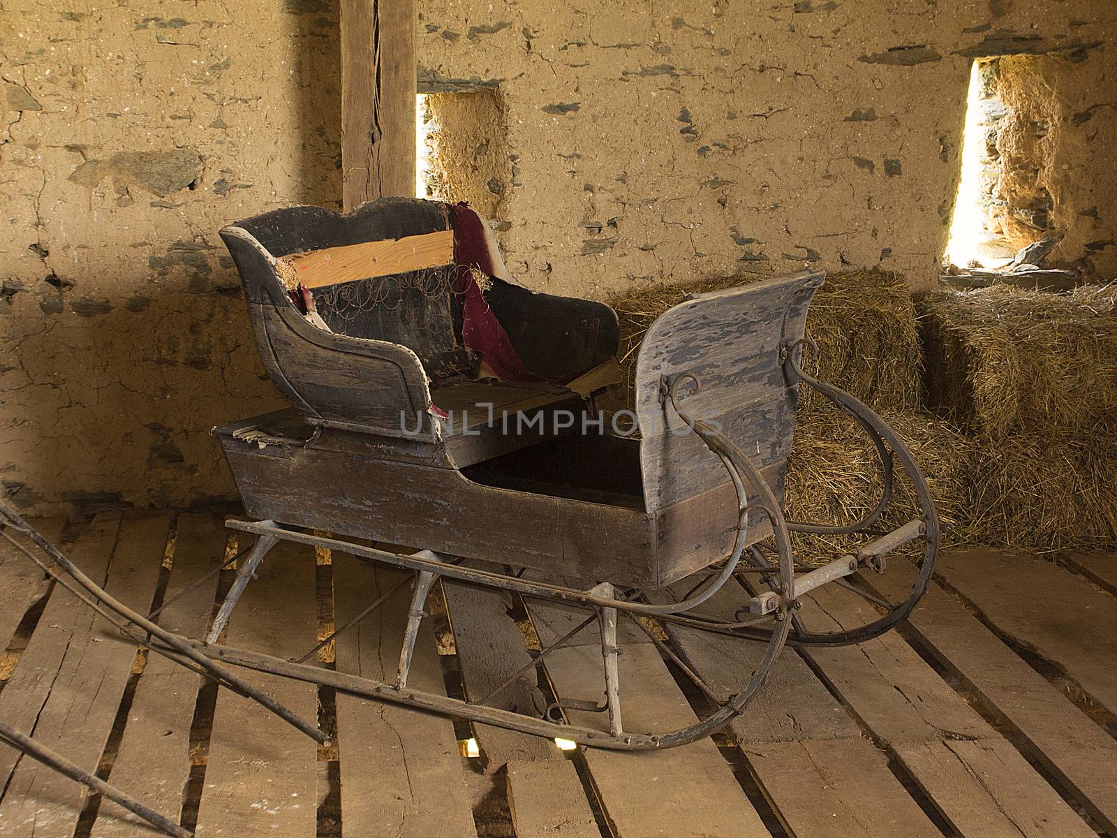 Old horse-drawn sleigh sitting in old barn