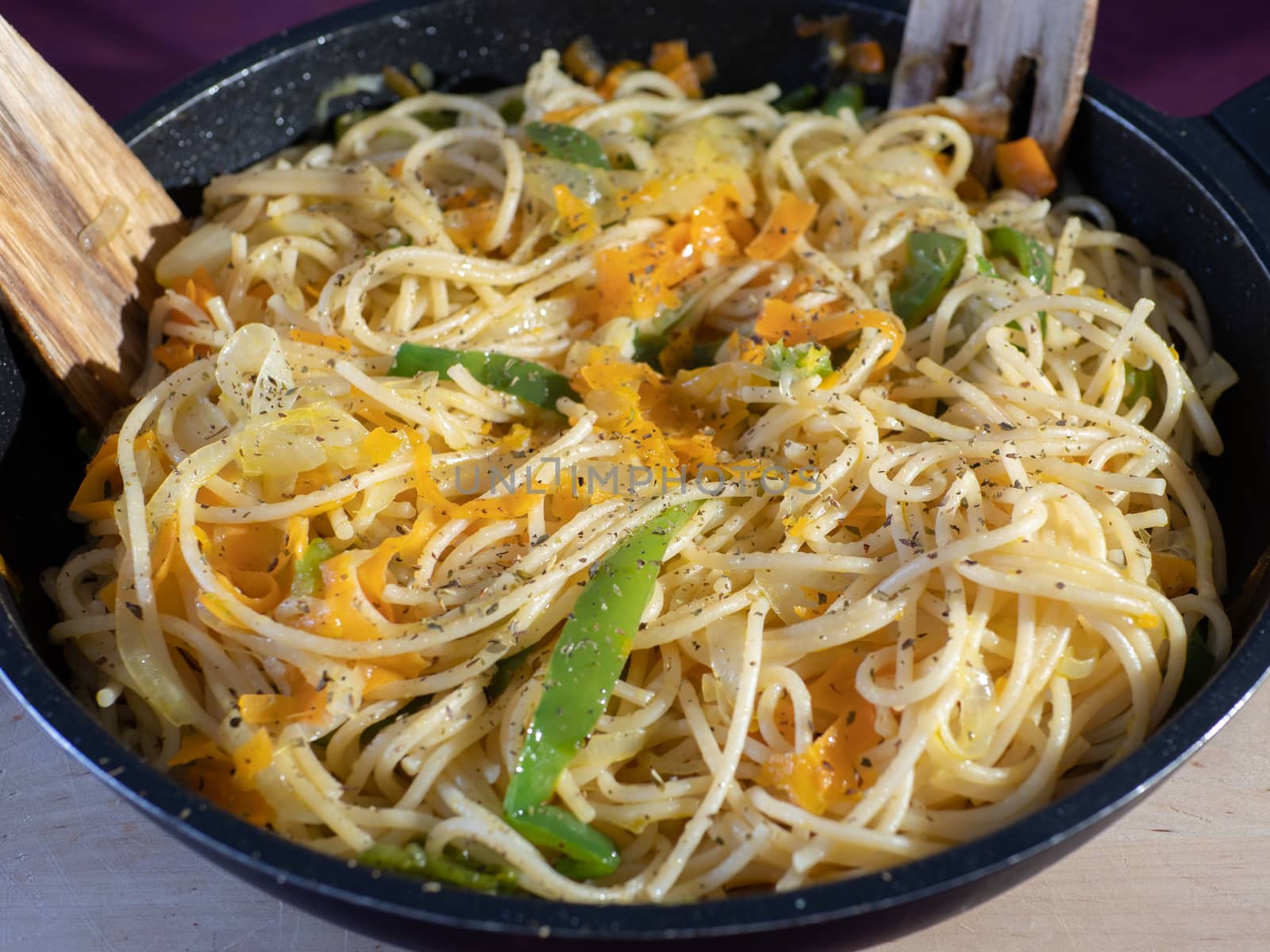 noodles with vegetables in a pan by jmagfoto