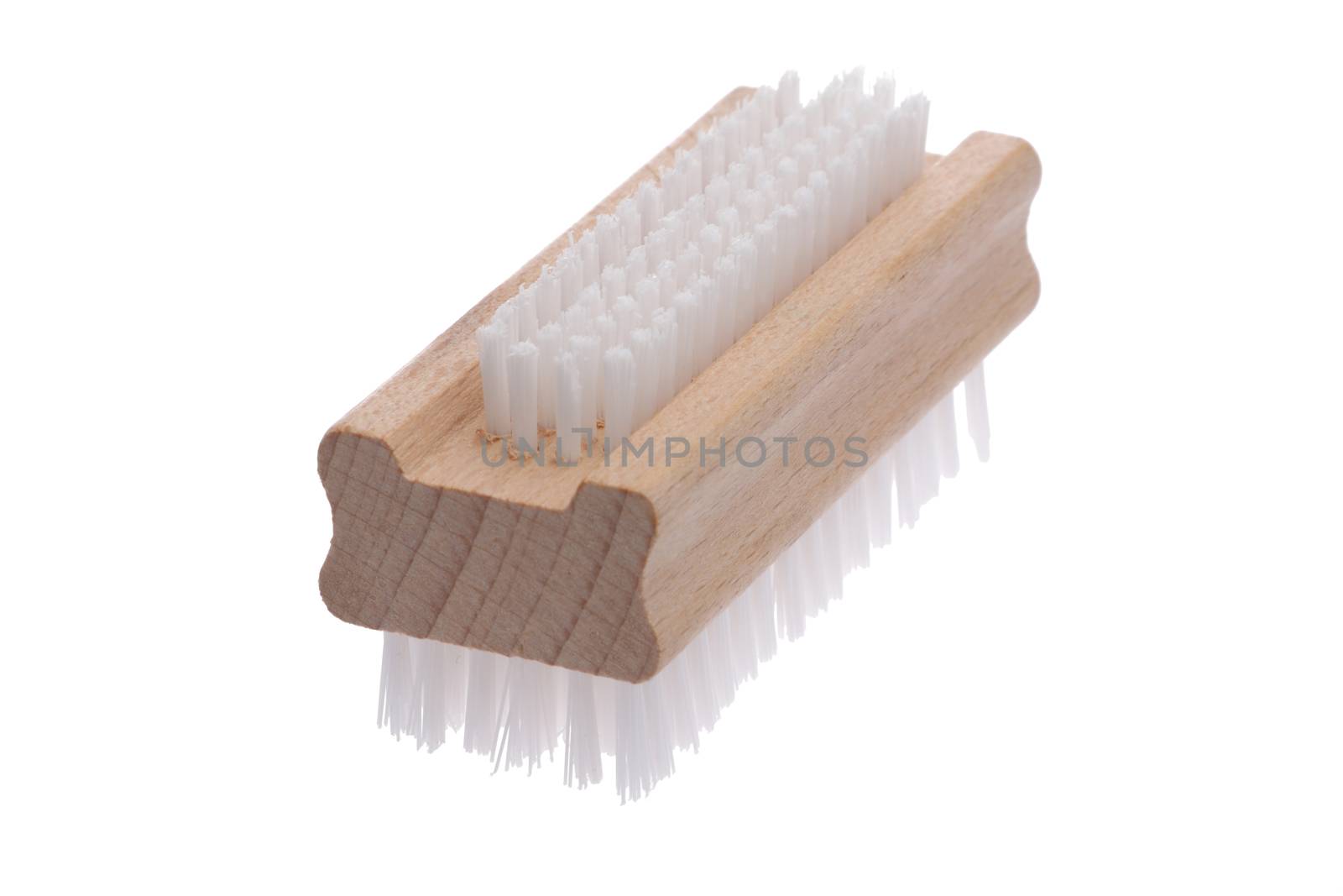 An old fashioned nail brush angled left to right with short bristles up isolated on white with clipping path