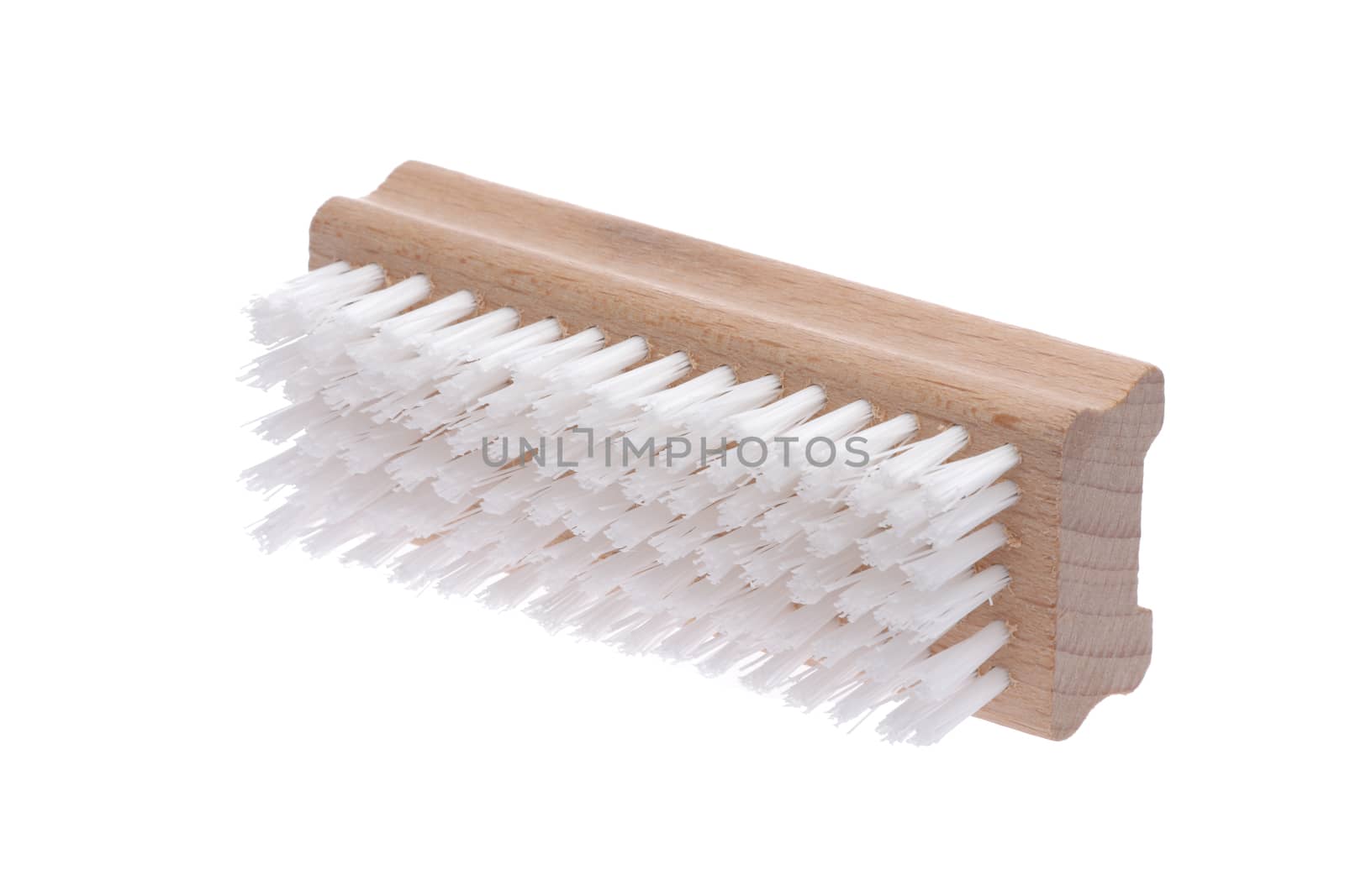 A retro wood nail brush with long bristles inclined on a white background