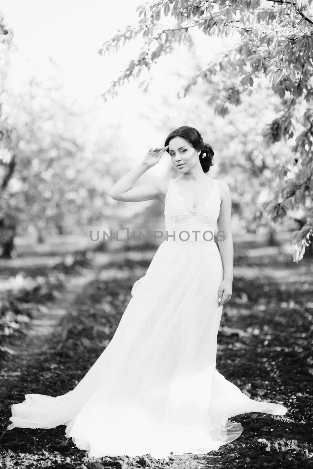 brunette girl in a turquoise dress in the spring garden by Andreua