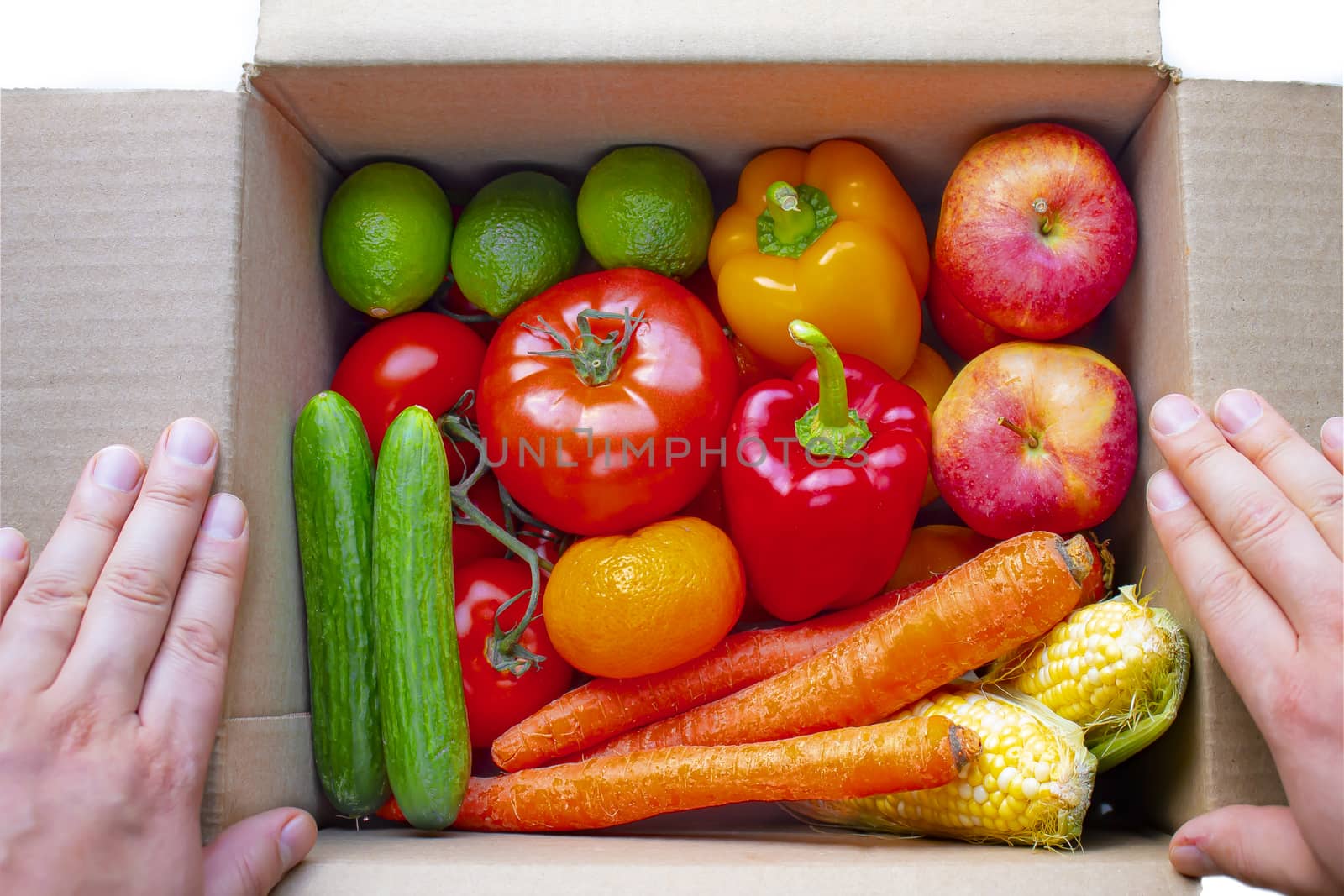 A person opening a deliver cardboard box with produce, fruits and vegetables inside on a white background by oasisamuel