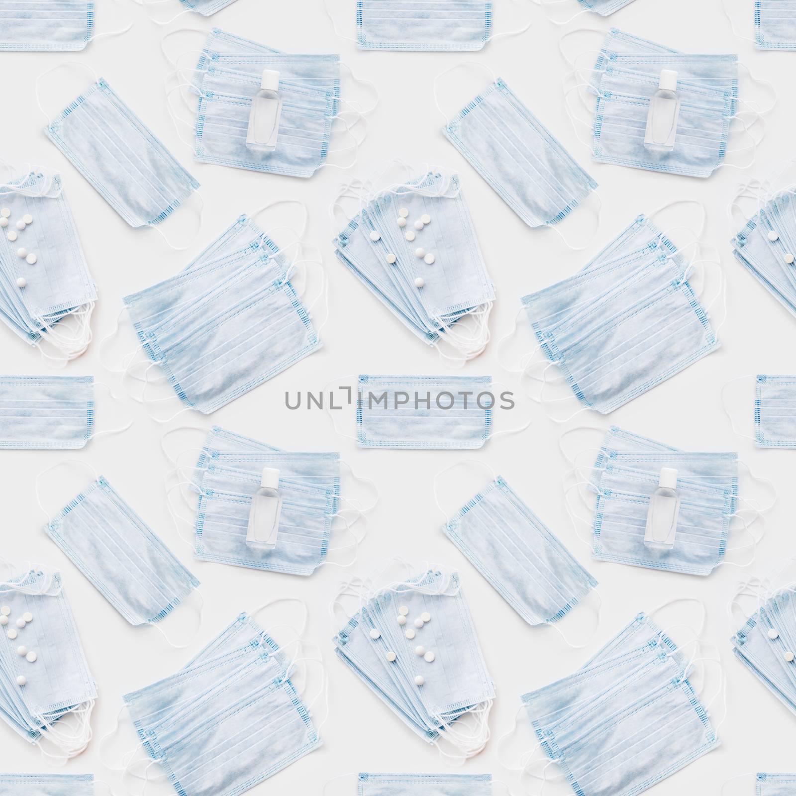 Top view on scattering blue protective medical masks, sanitizer gel and scattering pills. Photo seamless pattern of medical masks. Coronavirus COVID-19 concept on white background.