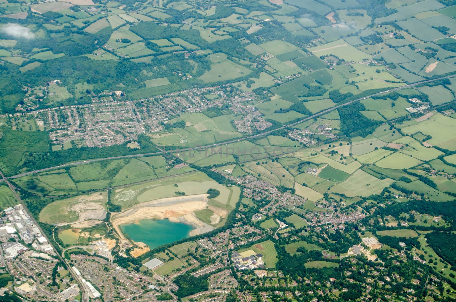 Aerial view of Sevenoaks in Kent with the Tarmac  quarry towards the left hand side.  The quarry provides sand for mortar in construction.  The M26 motorway runs across the middle of the image with the village of Kemsing to the north.   