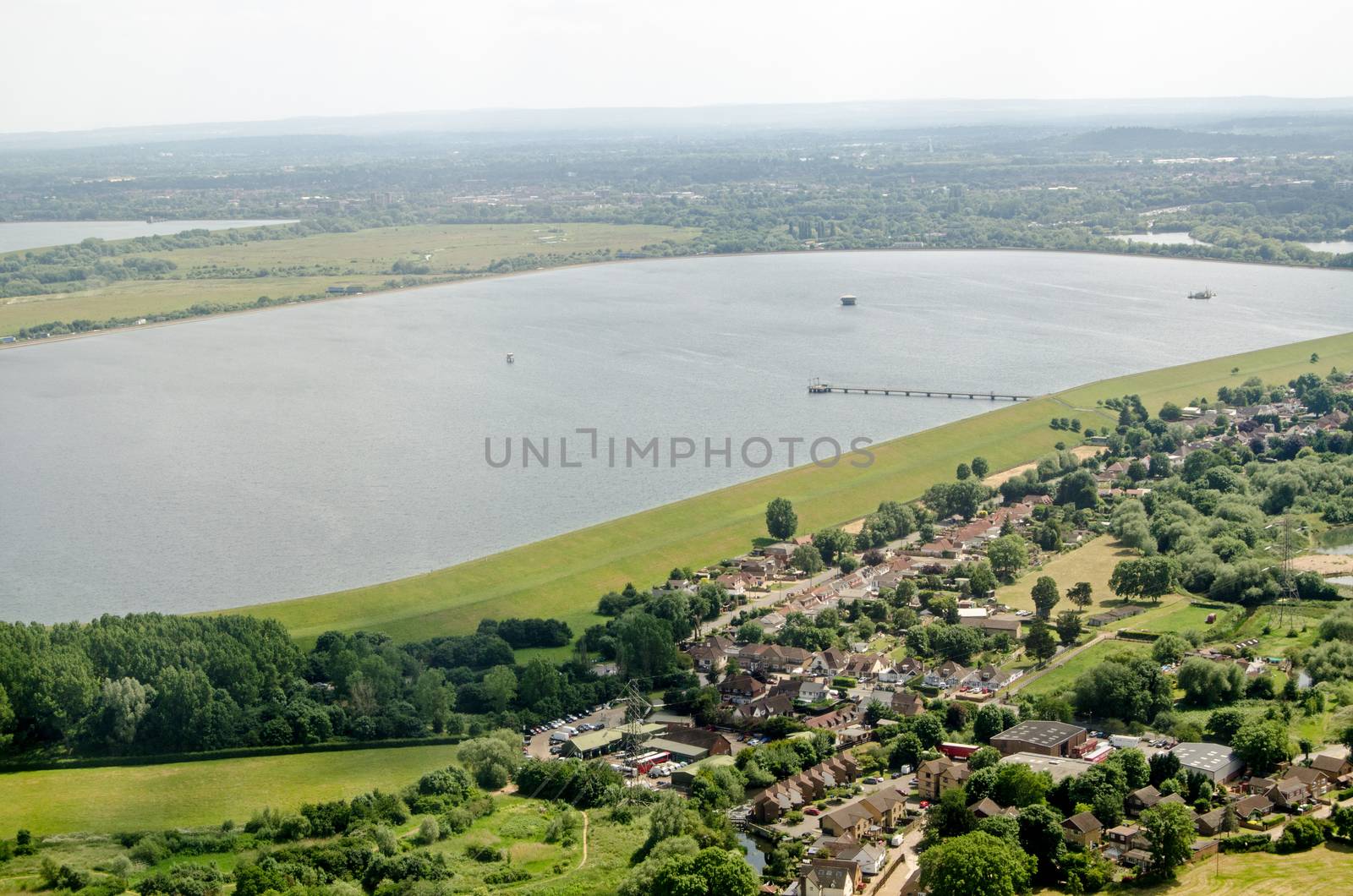 Aerial view on the approach to London's Heathrow Airport of the Wraysbury Reservoir in Slough, Berkshire which supplies water to West London.  Beyond the water is part of the M25 Motorway. 
