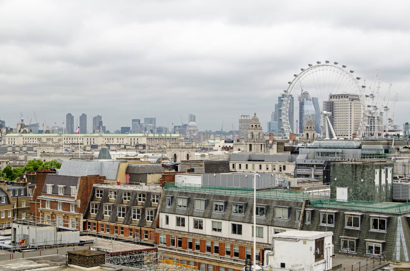 View across the rooftops of Westminster towards the South Bank and City of London on a cloudy summer day.  View includes St Paul's Cathedral, the Ministry of Defence, the Barbican and the Shell building.