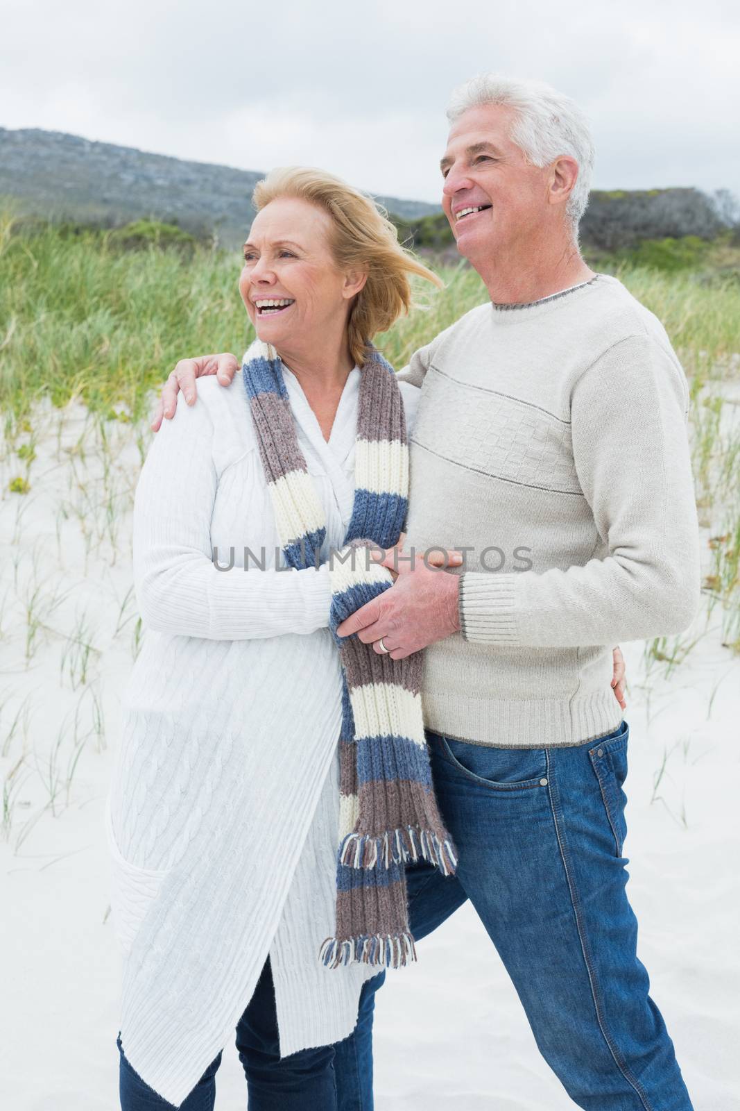 Cheerful romantic senior man and woman at the beach